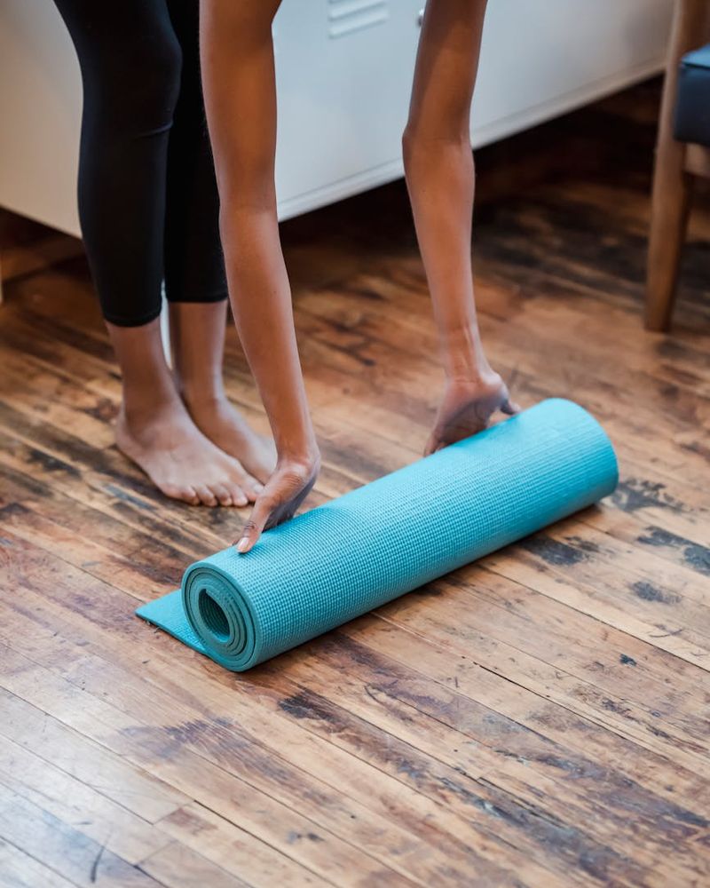 A bright, spacious room with a yoga mat on the floor, ready for practice.